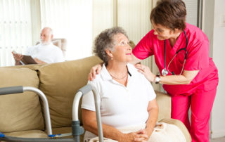 nurse leaning in to speak to elderly woman