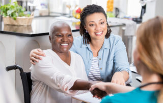 Mid adult woman talks with her mom's nurse